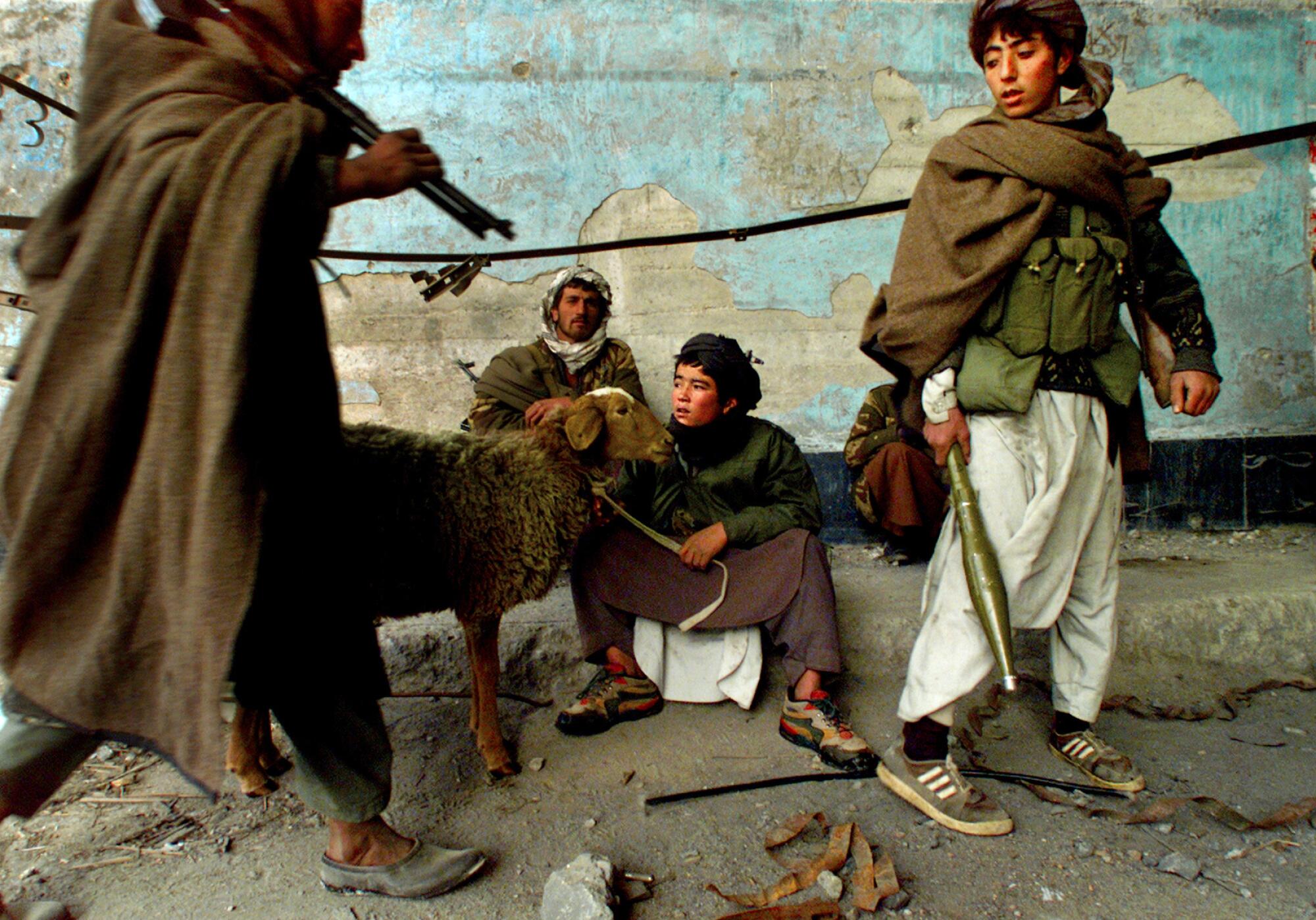 A young Taliban soldier watches after a sheep as they enter the Salang Tunnel in Afghanistan.