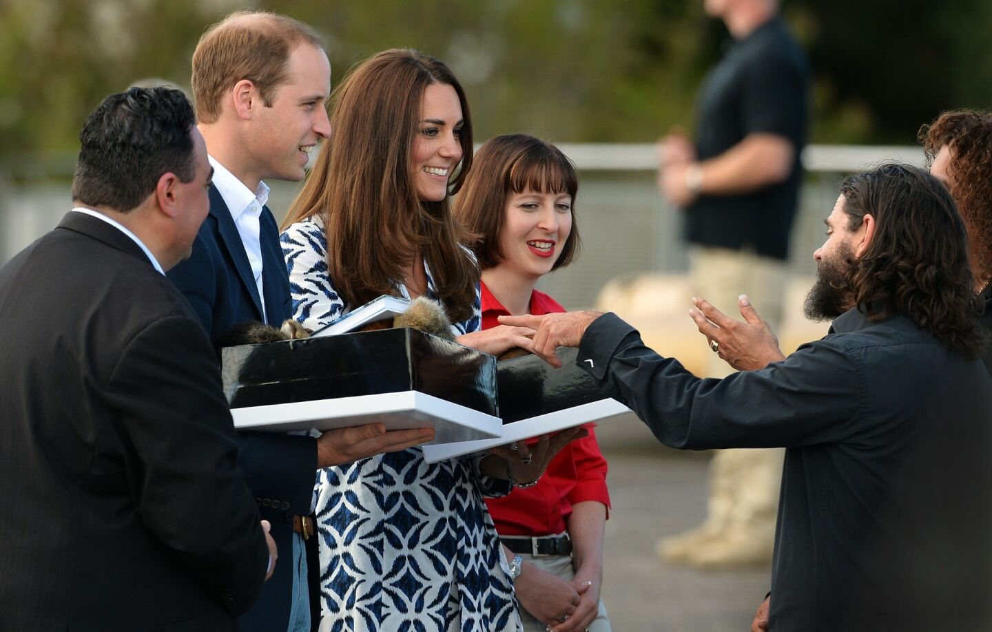 The duke and duchess are presented with gifts during a tour of the Three Sisters landmark.