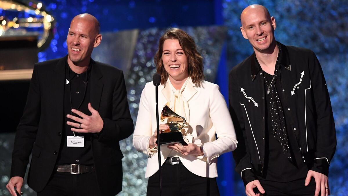 Brandi Carlile, center, accepts the award for American roots song for "The Joke" onstage during the 61st Grammy Awards pre-telecast show on Sunday.