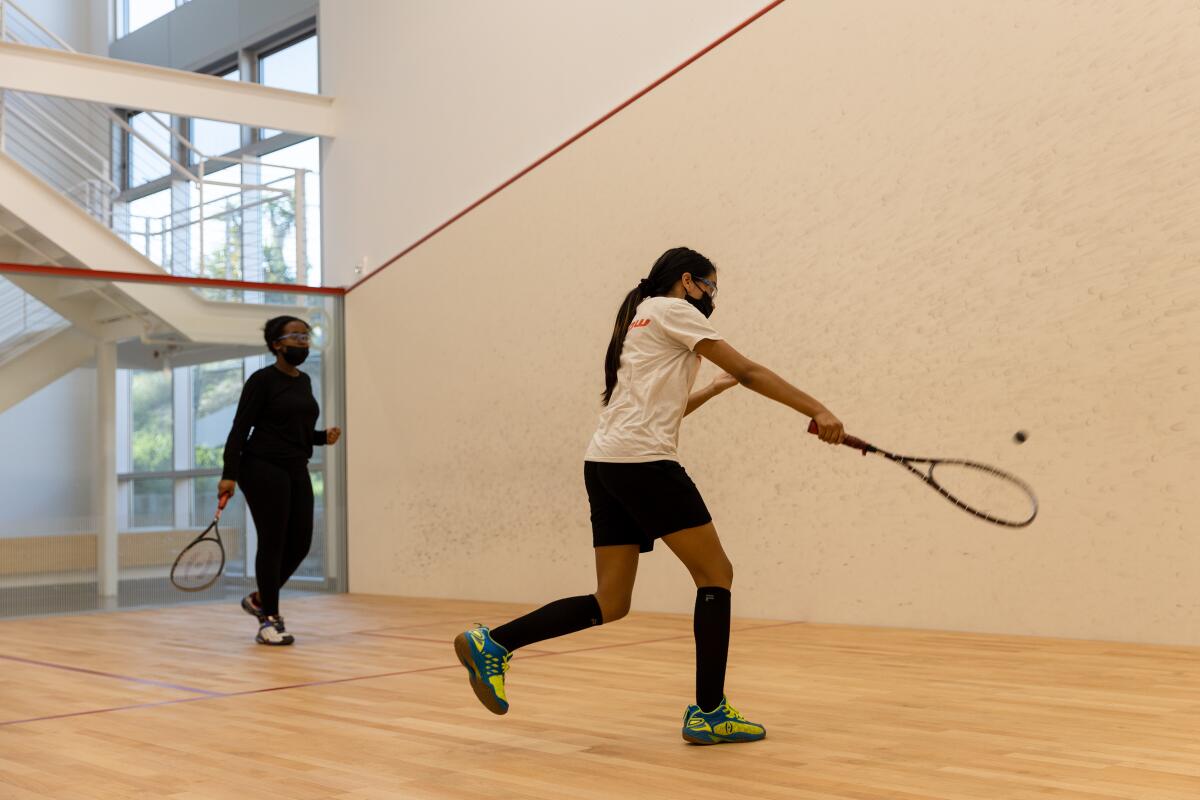 KIPP Adelante Preparatory Academy student Briana Hernandez and Preuss School student Nardos Ekubasla play squash