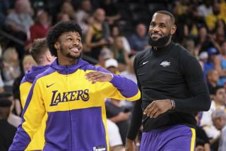 Los Angeles Lakers guard Bronny James, left, and forward LeBron James warm up before a preseason game