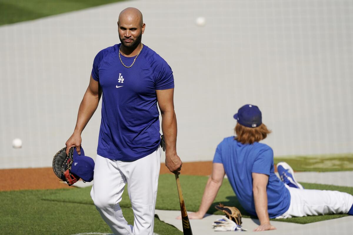 Dodgers first baseman Albert Pujols, left, walks away after batting practice before Monday's game.