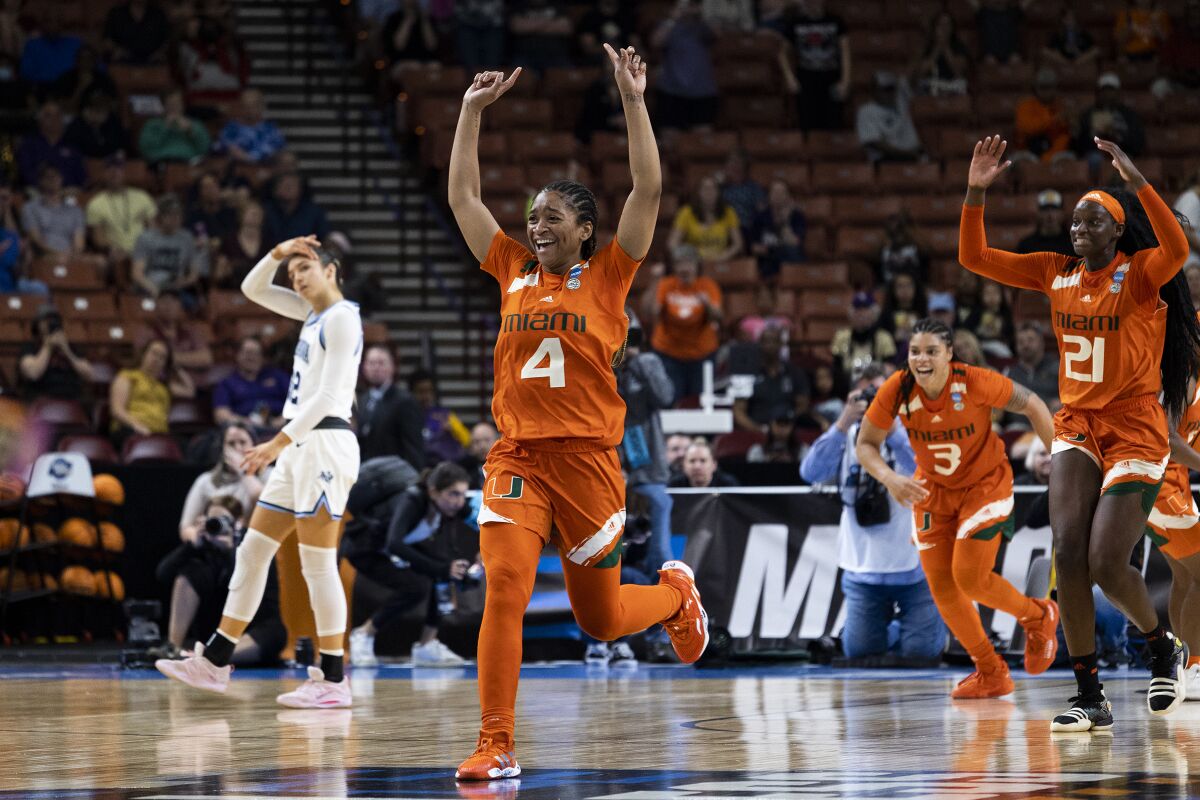 Miami's Jasmyne Roberts (4) runs after defeating Villanova in a Sweet 16 college basketball game of the NCAA Tournament in Greenville, S.C., Friday, March 24, 2023. (AP Photo/Mic Smith)