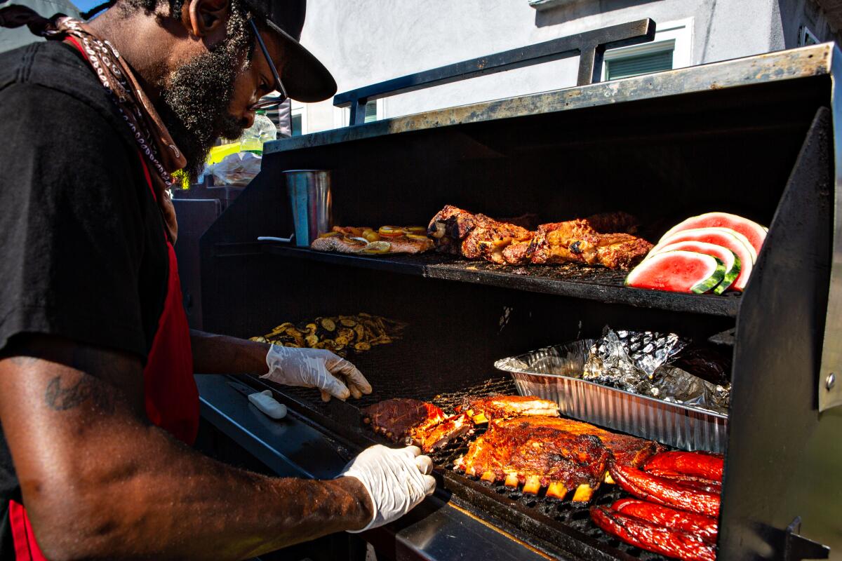 Chef Armond Keys, owner of Bootsy's BBQ, works the grill at his West Adams home.