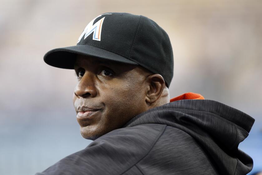 FILE - In this April 27, 2016, file photo, Miami Marlins hitting coach Barry Bonds stands in the dugout.
