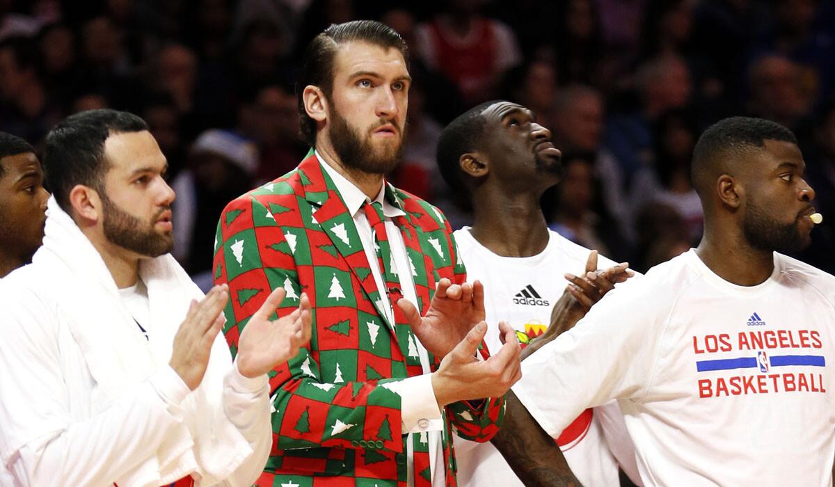 Clippers center Spencer Hawes, nursing an injured knee, sports holiday-themed attire as he cheers for his teammates against the Warriors on Thursday.