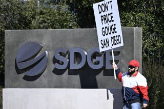 Bibian Harrison protests rate hikes in front of SDG&E headquarters Feb. 6, 2023 in San Diego. (Photo by Denis Poroy)