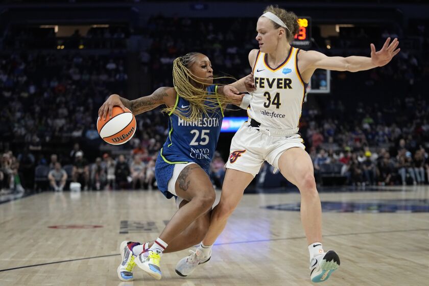 Minnesota Lynx guard Tiffany Mitchell (25) works toward the basket while defended by Indiana Fever guard Grace Berger (34) during the second half of a WNBA basketball game Friday, June 9, 2023, in Minneapolis. (AP Photo/Abbie Parr)