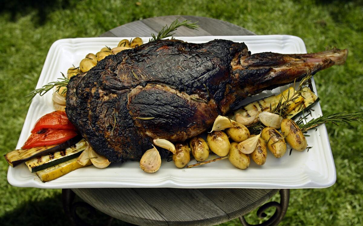 Barbecued leg of lamb with garlic confit, rosemary fingerlings and grilled vegetables