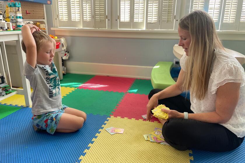Kate Gawlik of The Ohio State University College of Nursing plays a game with one of her four children.