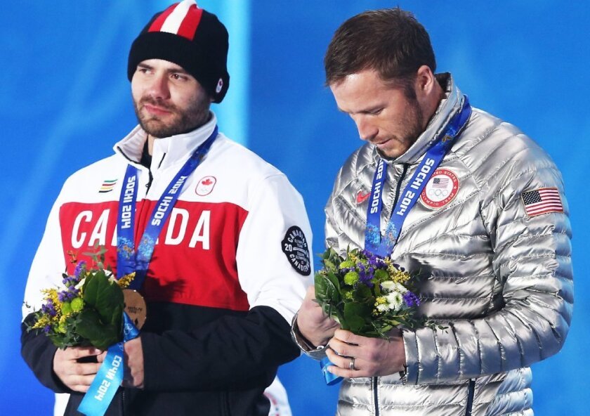Jan Hudec of Canada and the American skier Bode Miller during the medal ceremony for men's super-G event at the Sochi 2014 Olympic Games. NBC has been criticized for a post-race interview with Miller.