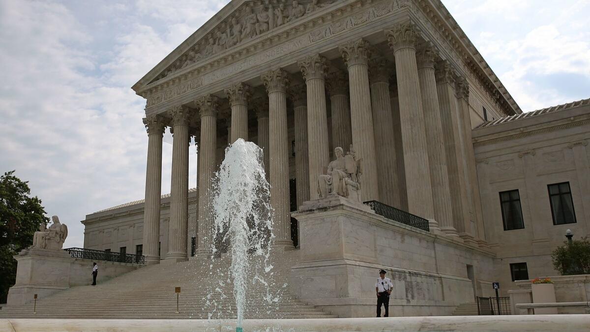 A guard stands outside the U.S. Supreme Court in Washington, DC.