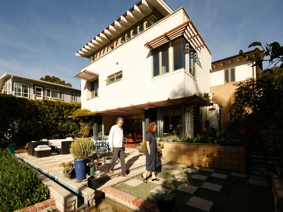 The backyard of the Santa Barbara home of architect Kevin Dumain and his wife, Jill, emphasizes indoor-outdoor living.
