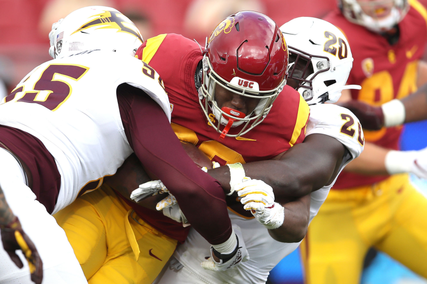 USC running back Markese Stepp, center, is tackled by Arizona State's Cam Phillips, left, and Darien Butler.