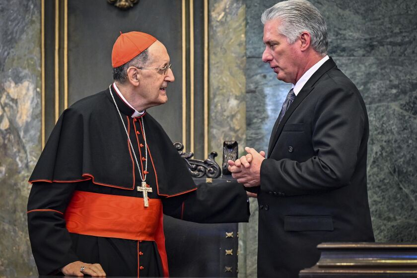 Cuban President Miguel Diaz Canel, right, talks with Cardinal Beniamino Stella during a ceremony marking the 25th anniversary of St. Paul II's apostolic journey to Cuba, at Havana University in Havana, Cuba, Wednesday, Feb. 8, 2023. Stella arrived in Cuba as Pope Francis’ special envoy on Jan. 24. (Adalberto Roque/Pool photo via AP)