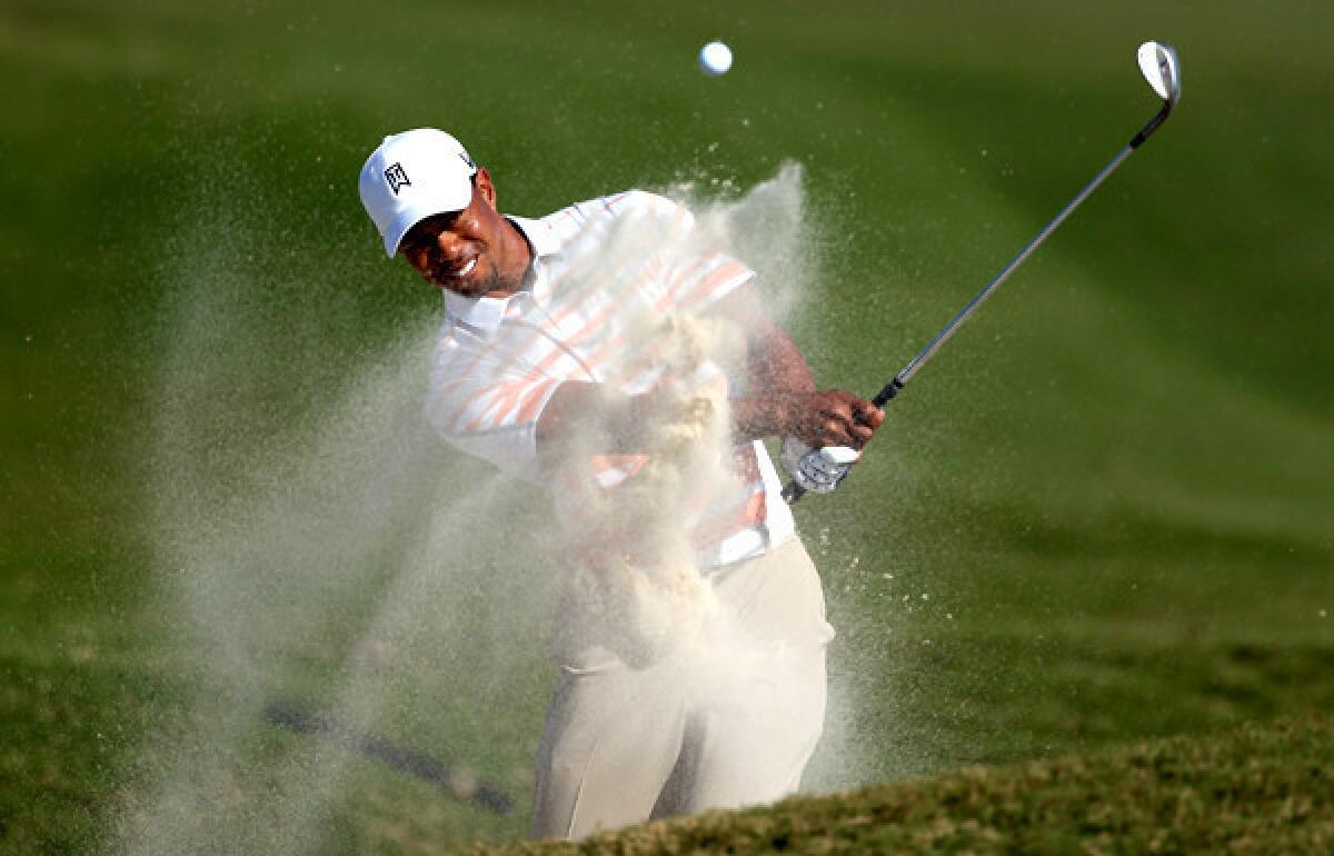 Tiger Woods hits out of a greenside bunker at No. 10 during the second round of the Cadillac Championship on Friday.