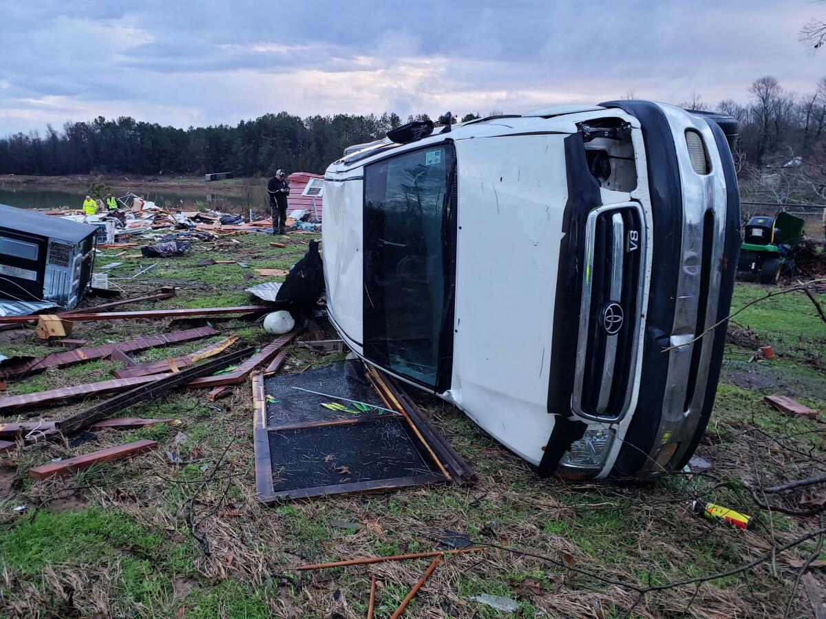 A white truck turned on its side amid damage from severe weather in Bossier Parish, Louisiana