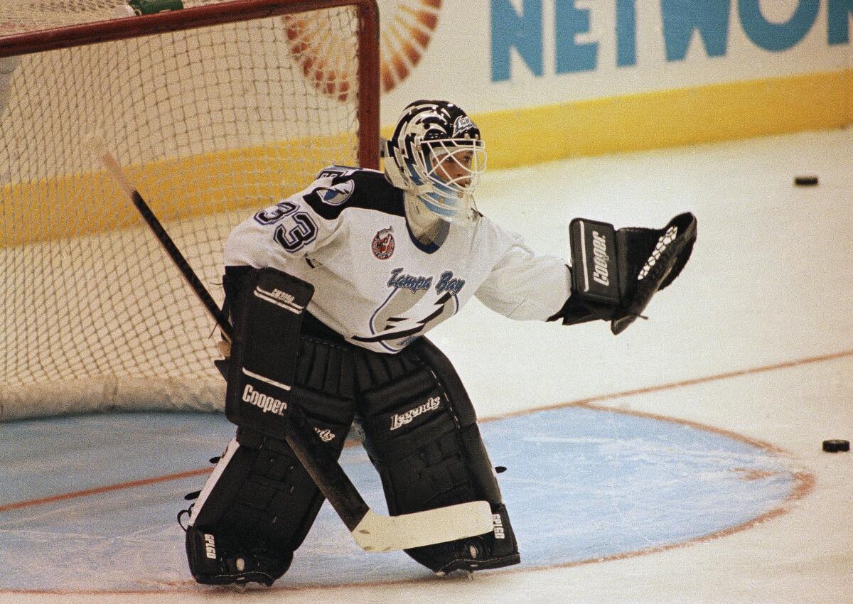 Tampa Bay Lightning goaltender Manon Rheaume uses her glove to make a save during her professional debut.