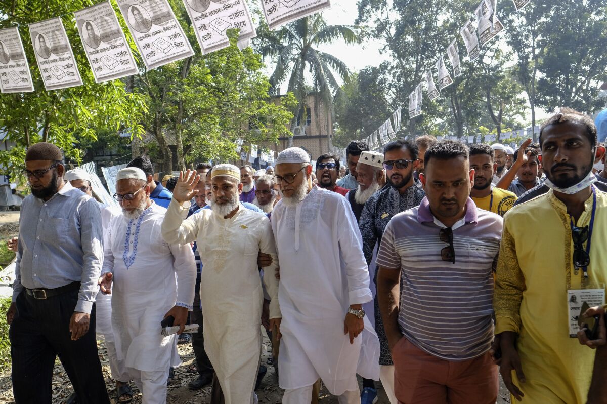 Ruling Awami League party candidate Nesar Ullah, third left, campaigns with his supporters in Srinagar, Munshiganj district, Bangladesh, Friday, Nov. 5, 2021. Bangladesh is holding a series of local elections to choose representatives at the village level amid a boycott by the country's largest opposition party in a country where the recent national vote was grossly disputed. The Awami League party of Prime Minister Sheikh Hasina is all but certain to win Thursday's election for 848 rural councils. (AP Photo/Mahmud Hossain Opu)