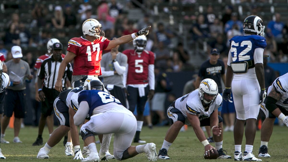 Quarterback Philip Rivers sets the Chargers offense during a practice with the Rams on Saturday at StubHub Center.
