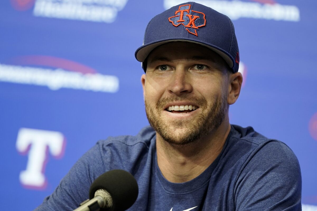 Texas Rangers starting pitcher Jacob deGrom takes questions from media before a spring training baseball game against the Kansas City Royals on Tuesday, March 28, 2023, in Arlington, Texas. (AP Photo/Sam Hodde)
