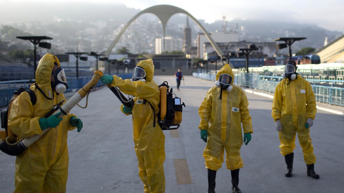 Health workers in Rio de Janeiro get ready to spray insecticide to combat mosquitoes that transmit the Zika virus.