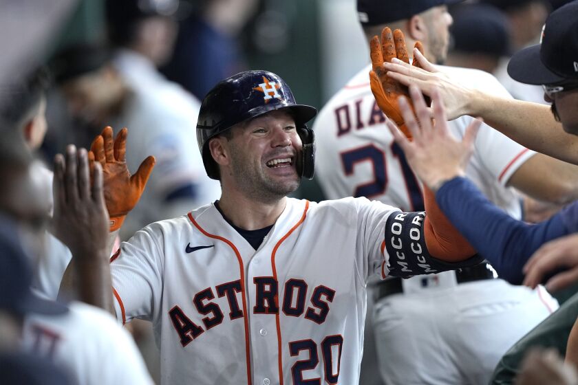 Houston Astros' Chas McCormick (20) celebrates in the dugout after hitting a home run against the Los Angeles Angels during the seventh inning of a baseball game Saturday, June 3, 2023, in Houston. (AP Photo/David J. Phillip)