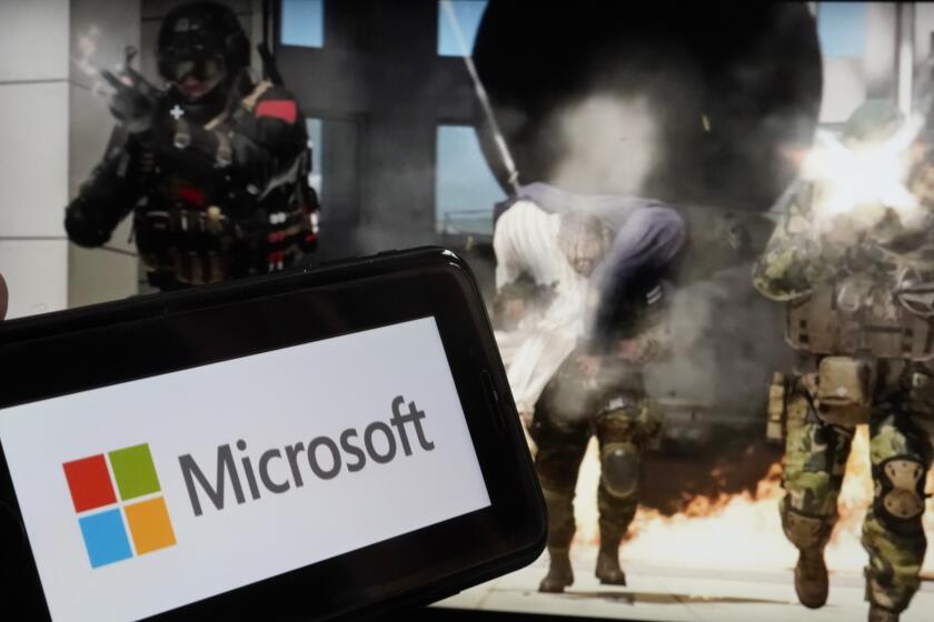 File - The logo for Microsoft, and a scene from Activision "Call of Duty - Modern Warfare," are shown in this photo, in New York, Wednesday, June 21, 2023. A judge handed Microsoft a big victory on Tuesday, declining to stop its $69 billion takeover of video game maker Activision Blizzard. (AP Photo/Richard Drew, File)