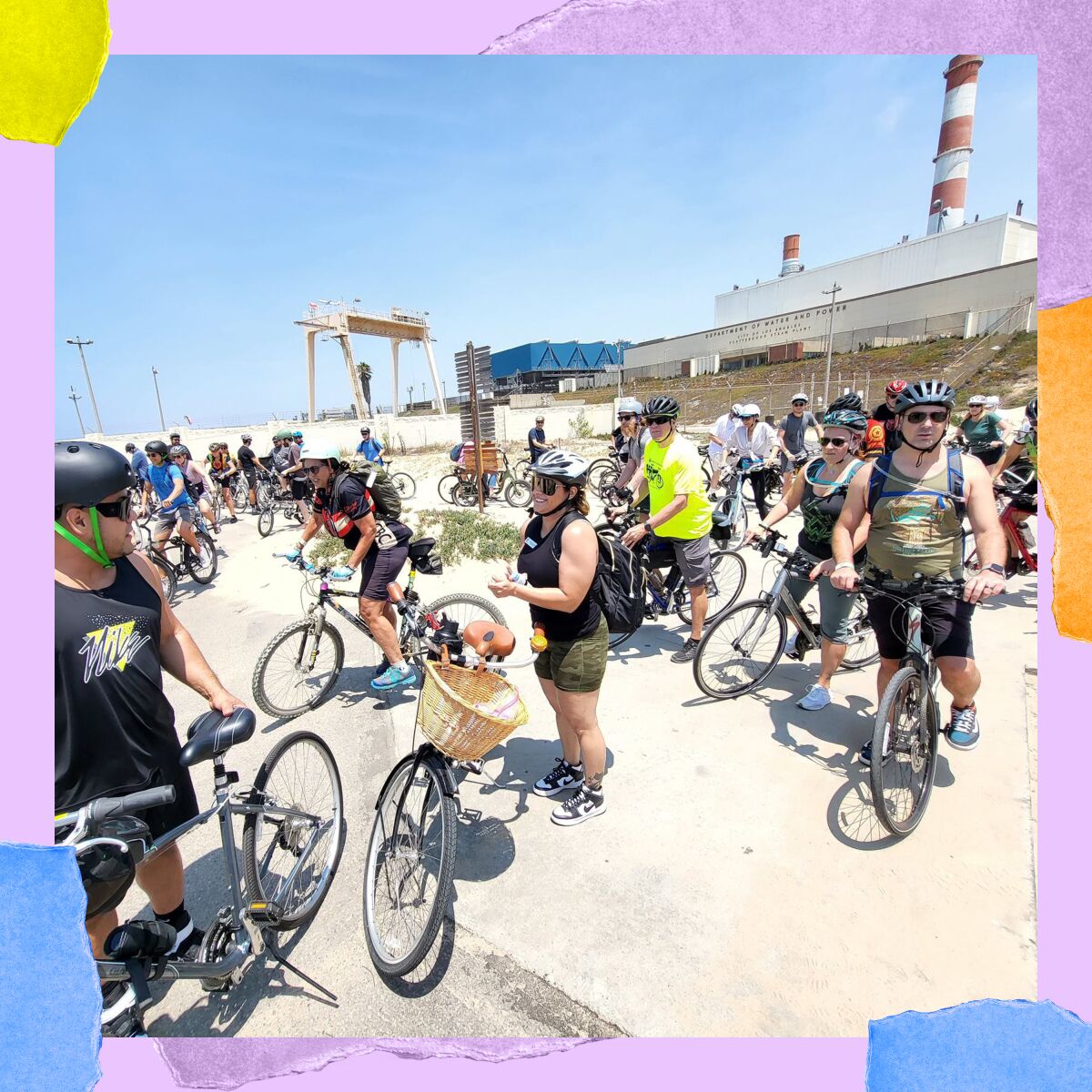 A crowd of cyclists, most in shorts and bike helmets. 