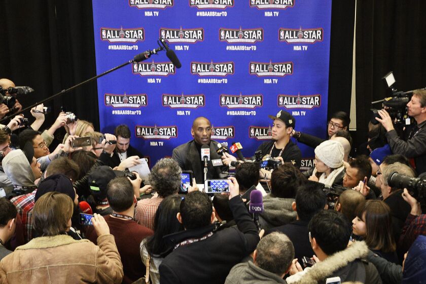 Lakers All-Star Kobe Bryant, center, talks to reporters during a news conference leading up to the NBA All-Star game in Toronto.