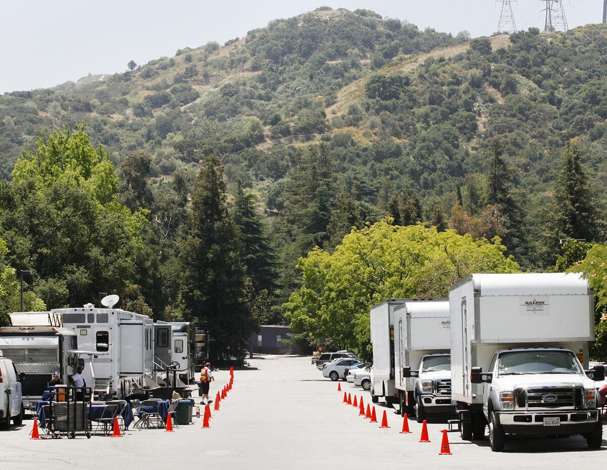 A caravan of production vehicles line up for a McDonald's commercial film shoot at Descanso Gardens in La Cañada Flintridge.
