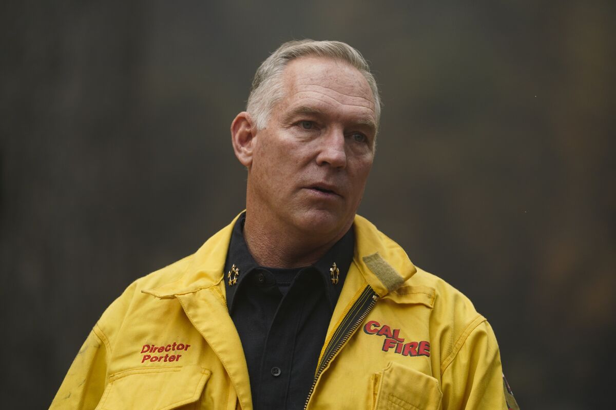 FILE - Cal Fire Chief Thom Porter tours the area scorched by the Caldor Fire in Eldorado National Forest, Calif., Wednesday, Sept. 1, 2021. Porter, the chief of California's forestry and wildland firefighting agency, announced Monday, Nov. 15, 2021 that he will retire next month after shepherding the state through three historic wildfire seasons, the most recent of which saw two massive blazes span the Sierra Nevada for the first time in recorded history. (AP Photo/Jae C. Hong,File)
