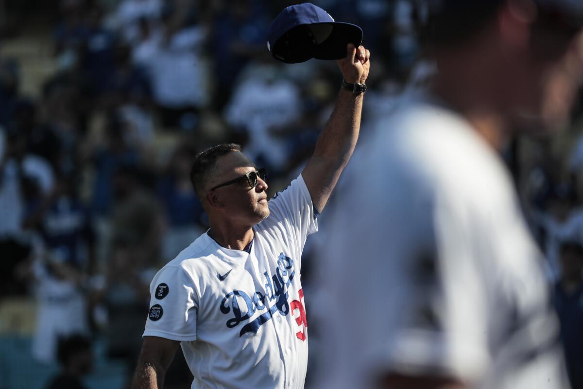 Dave Roberts salutes the crowd after the final game of the regular season.