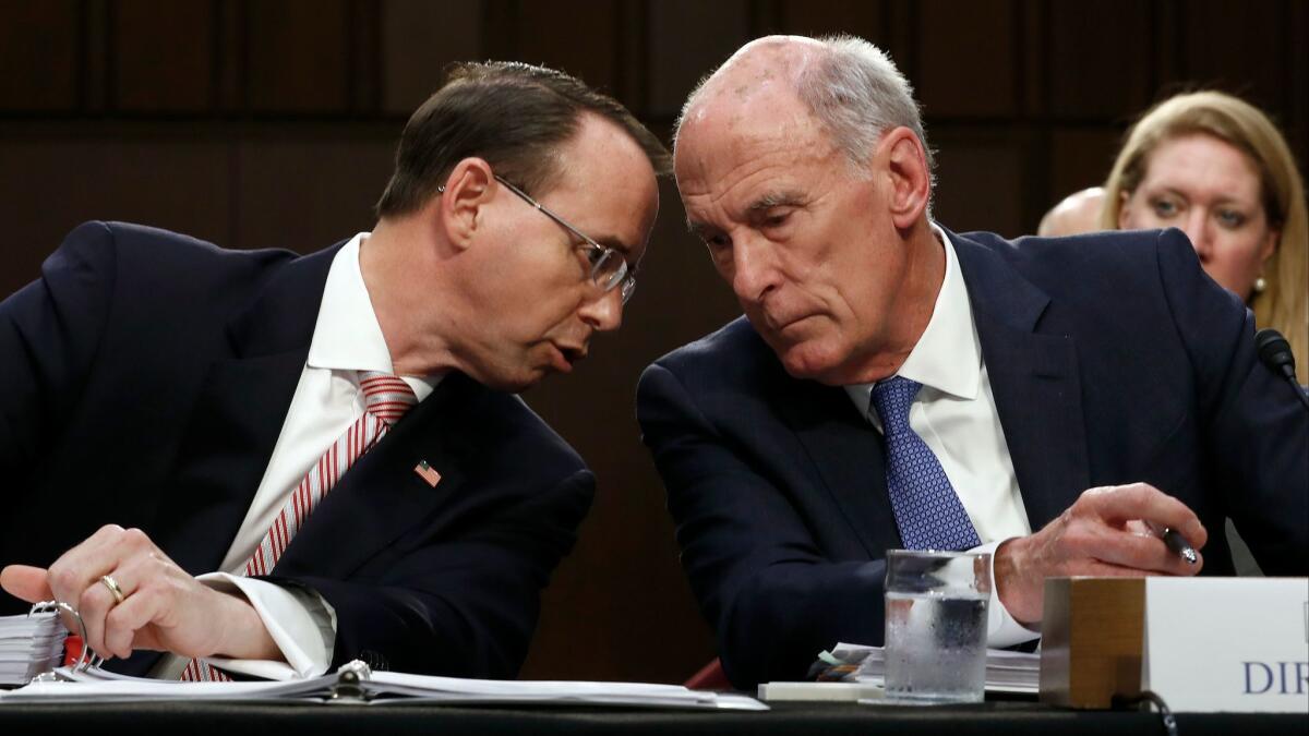 Deputy Atty. Gen. Rod Rosenstein, left, and Director of National Intelligence Dan Coats, talk on Capitol Hill last year.