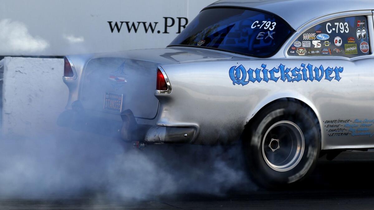 A driver burns rubber as a prelude to a drag race at Irwindale Speedway. The track hosts weekly racing and drifting events on Thursdays.