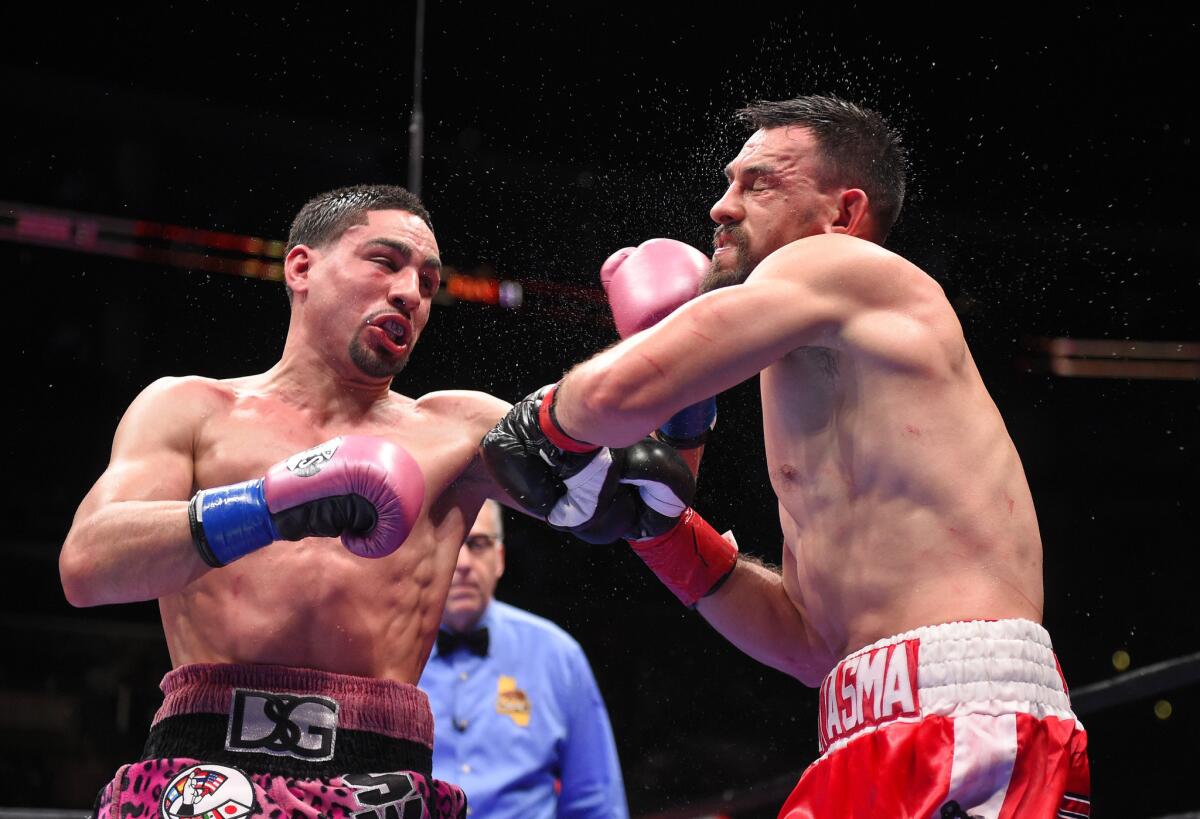 Danny Garcia, left, and Robert Guerrero trade punches in the middle of the ring during their WBC welterweight title fight on Jan. 23.