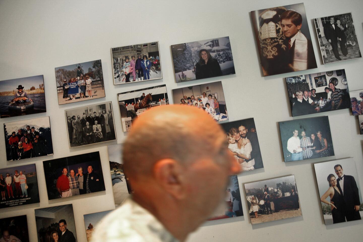 Ken Chiate with a wall of family photos in his Malibu home office.