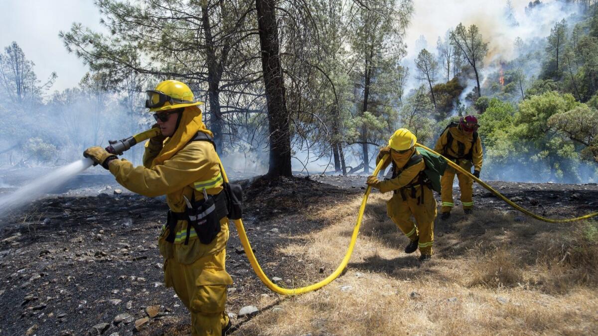 Fire crews battle the Pawnee wildfire near Cache Creek Road in Spring Valley, where hundreds of residents have been forced to flee.