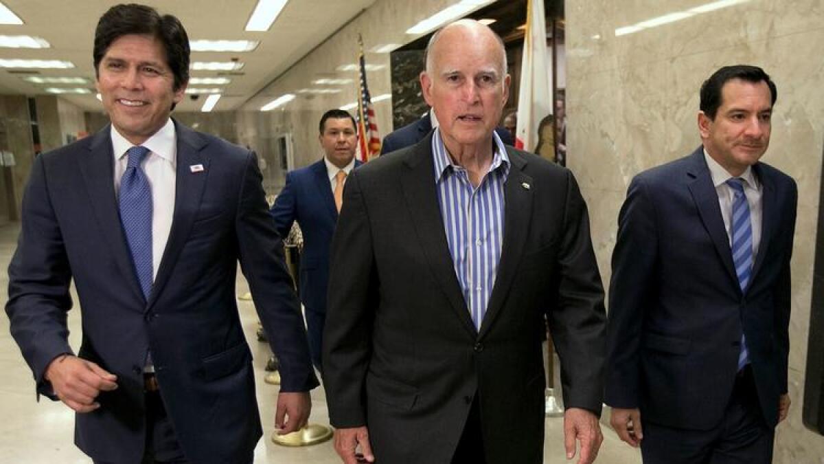 Senate leader Kevin de Leόn, left, Gov. Jerry Brown and Assembly Speaker Anthony Rendon after lawmakers approved new climate legislation this month.