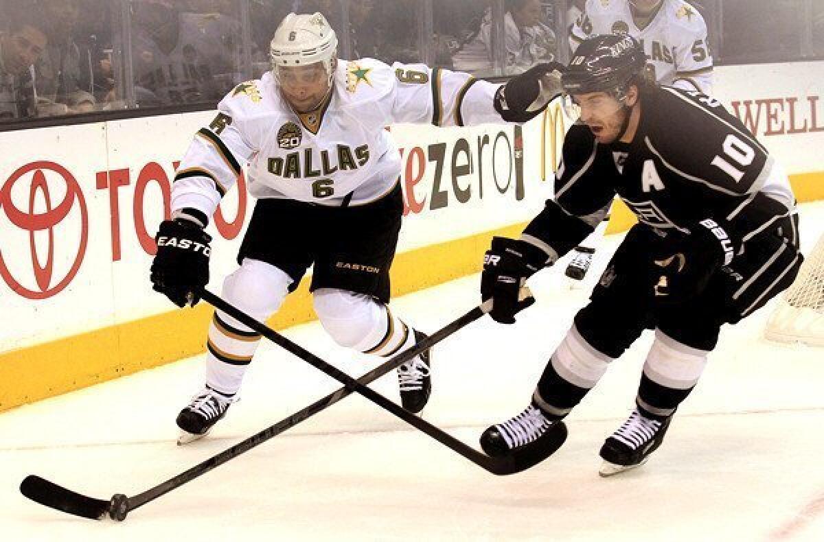 Kings center Mike Richards (10) tries to collect the puck against Stars defenseman Trevor Daly on Thursday night.