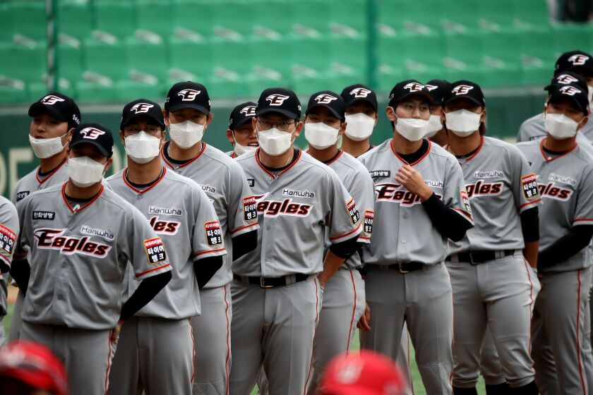 INCHEON, SOUTH KOREA - MAY 05: (EDITORIAL USE ONLY) Hanwha Eagles players wear masks before the Korean Baseball Organization (KBO) League opening game between SK Wyverns and Hanwha Eagles at the empty SK Happy Dream Ballpark on May 05, 2020 in Incheon, South Korea. The 2020 KBO season started after being delayed from the original March 28 Opening Day due to the coronavirus (COVID-19) outbreak. The KBO said its 10 clubs will be able to expand their rosters from 28 to 33 players in 54 games this season, up from the usual 26. Teams are scheduled to play 144 games this year. As they prepared for the new beginning, 10 teams managers said the season would not be happening without the hard work and dedication of frontline medical and health workers. South Korea is transiting this week to a quarantine scheme that allows citizens to return to their daily routines under eased guidelines. But health authorities are still wary of "blind spots" in the fight against the virus cluster infections and imported cases. According to the Korea Center for Disease Control and Prevention, 3 new cases were reported. The total number of infections in the nation tallies at 10,804. (Photo by Chung Sung-Jun/Getty Images)