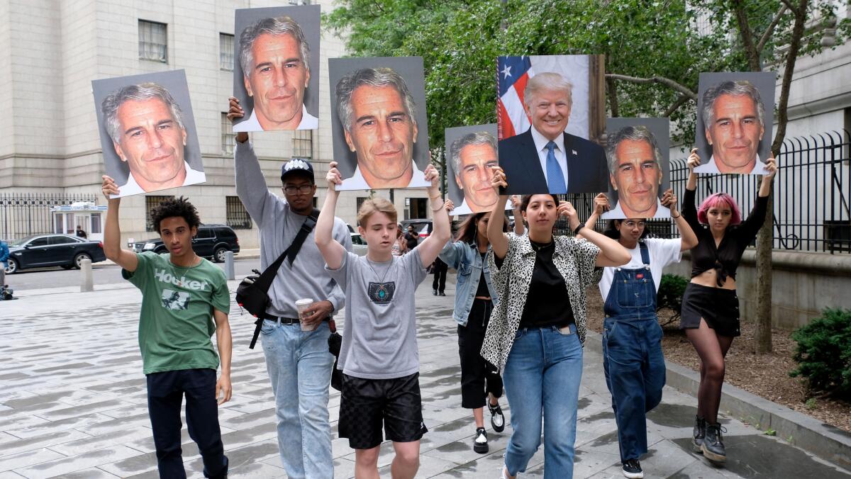 Young protesters carry pictures of Jeffrey Epstein and President Trump outside the court in Manhattan where Epstein was being charged with conspiracy and sex trafficking of minors.