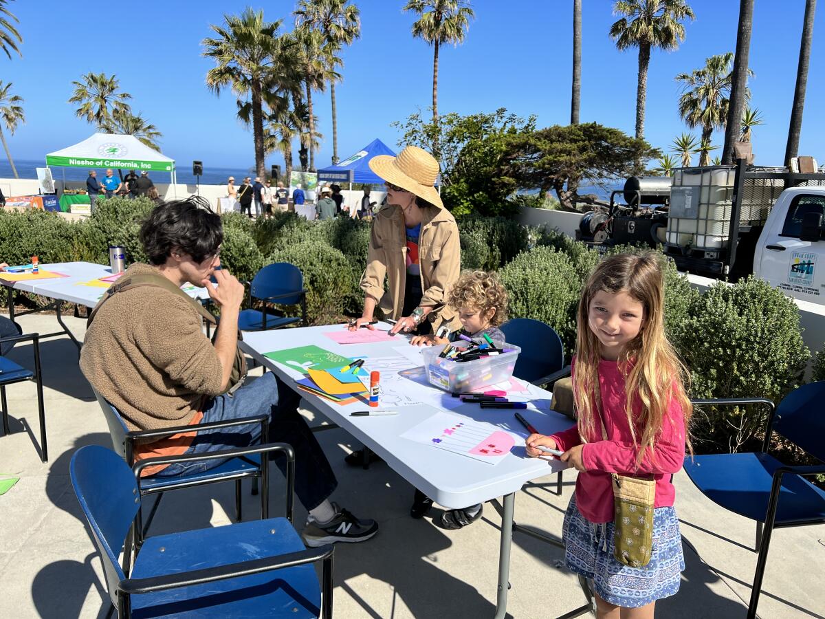 Declan Renfree (foreground) and younger brother Brooks participate in a flower art collage project sponsored by MCASD.