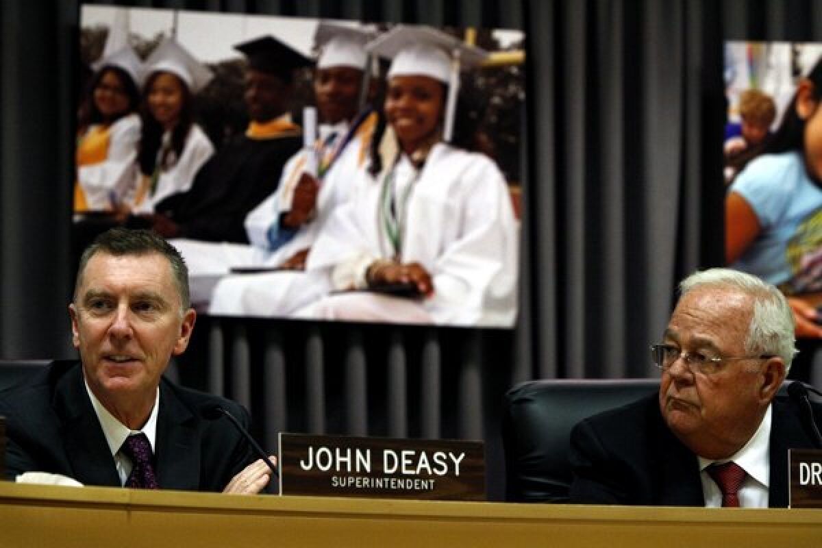 L.A. schools Supt. John Deasy, left, will continue to lead the nation's second-largest school district until 2016, the district's legal counsel announced Tuesday, ending days of rumors that he might resign. Deasy, 52, received a satisfactory evaluation from the Los Angeles Board of Education after a nearly five-hour performance review behind closed doors. He and board President Richard Vladovic, right, make brief remarks after the announcement.