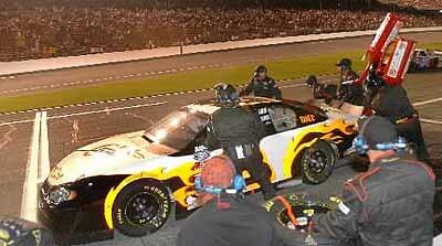 Dale Earnhardt Jr. comes in for fuel and tires during a pit stop on Lap 44 of the Winn-Dixie 250.