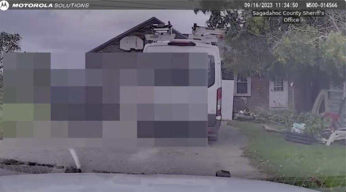 A photo of a van in front of a house, with information blurred out