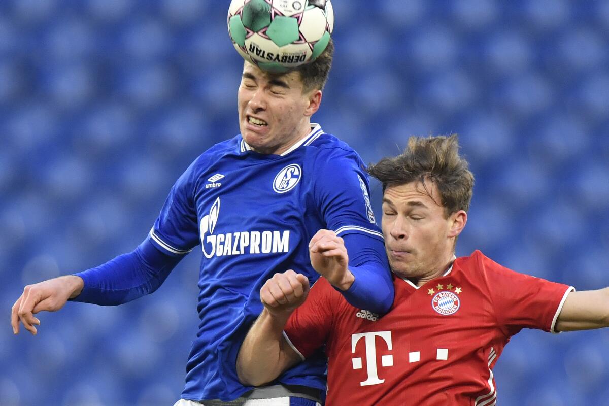Bayern's Joshua Kimmich, right, and FC Schalke's Matthew Hoppe battle for the ball during a match on Jan. 24.