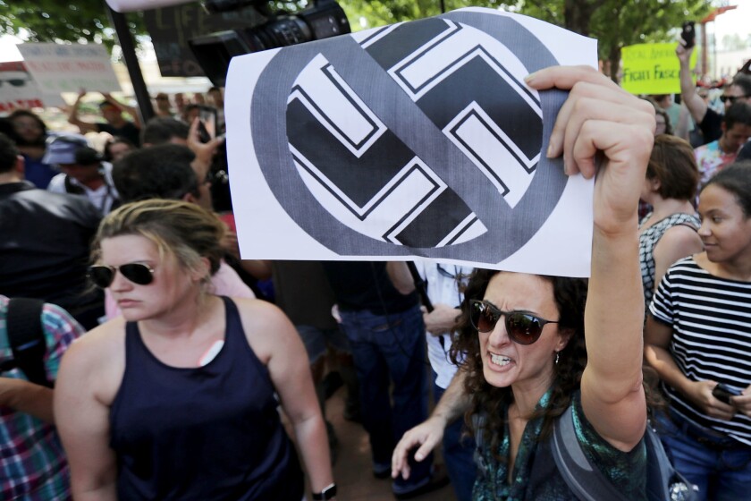 Protesters shout anti-Nazi chants after chasing alt-right blogger Jason Kessler from a news conference August 13, 2017 in Charlottesville, Va.