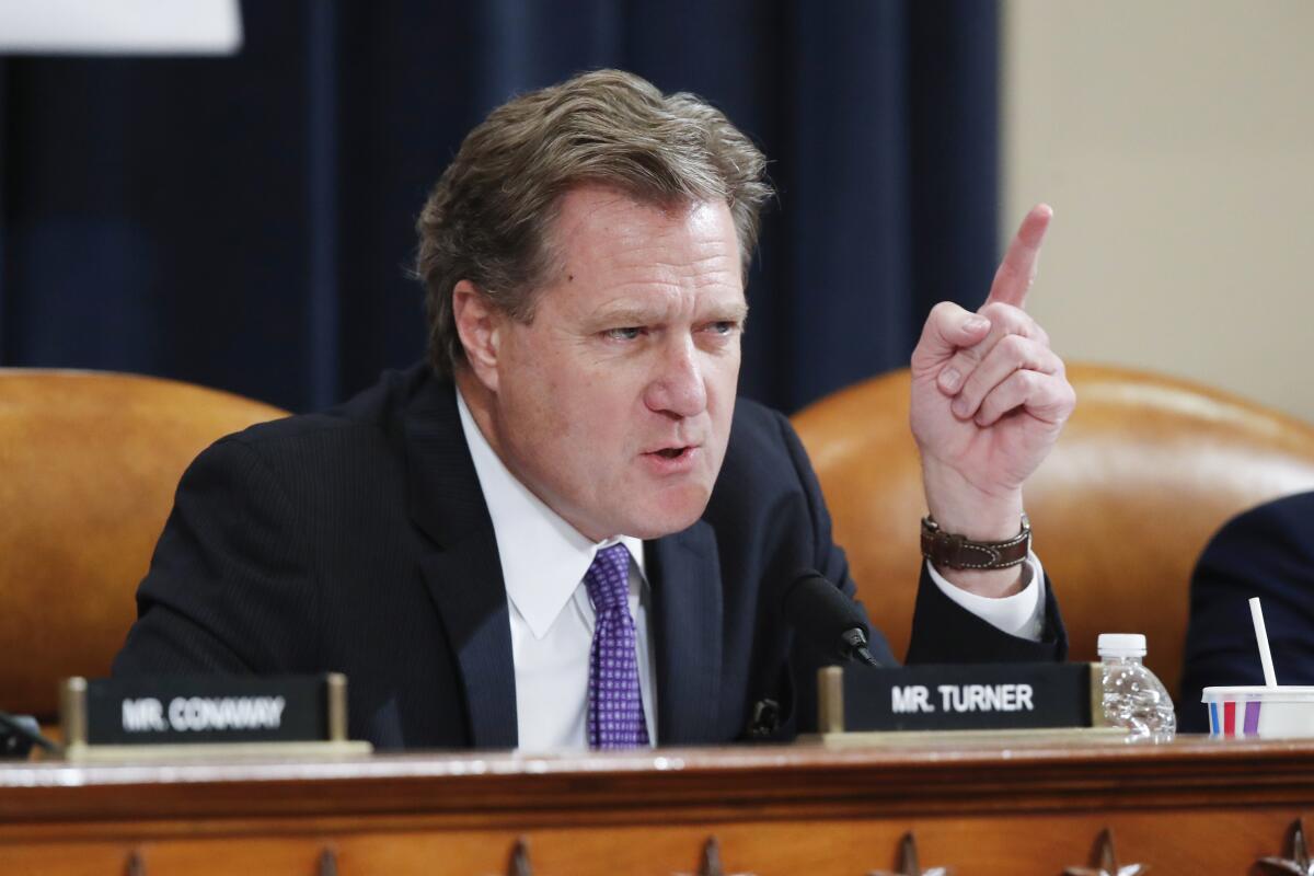 Rep. Mike Turner pointing as he speaks from a table on the dais during a hearing