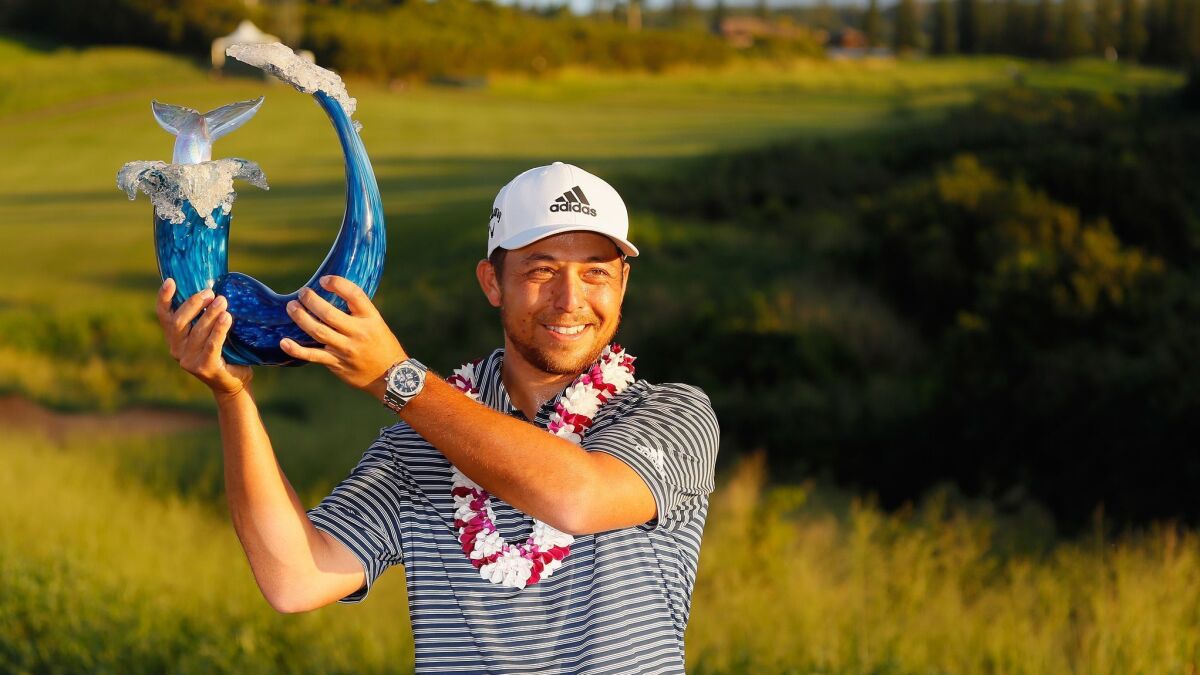 San Diegan Xander Schauffele poses with the trophy after winning the Sentry Tournament of Champions at the Plantation Course at Kapalua Golf Club on January 6, 2019 in Lahaina, Hawaii.